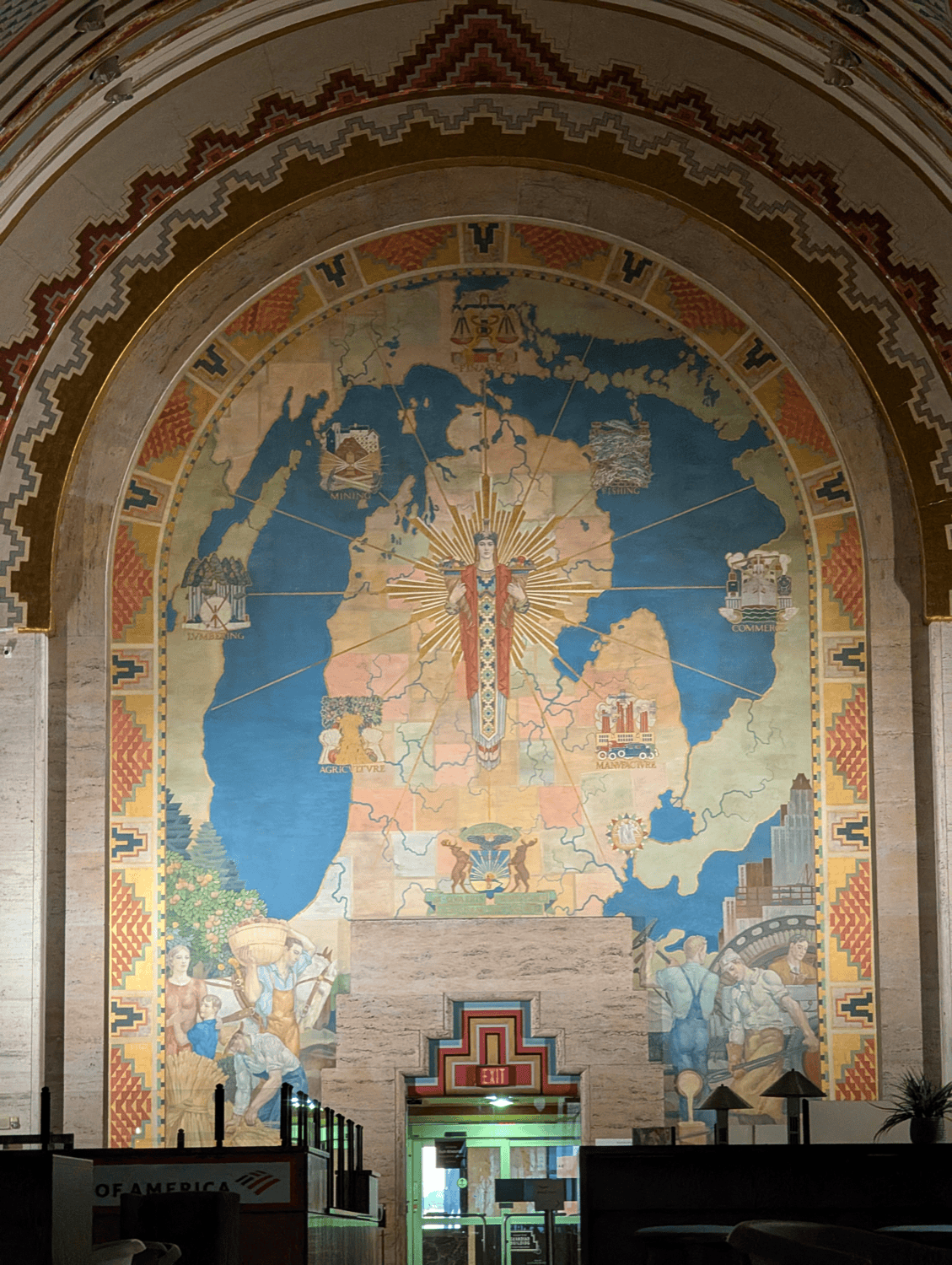 The Spirit of Detroit map mural showing Michigan flanked by Mining, Fishing, Lumbering, Agriculture, Manufacture, Commerce, and Finance