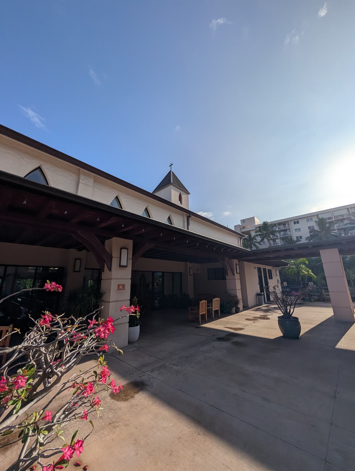 The covered lanai at St. Michael the Archangel, Kailua-Kona, with the bell tower behind
