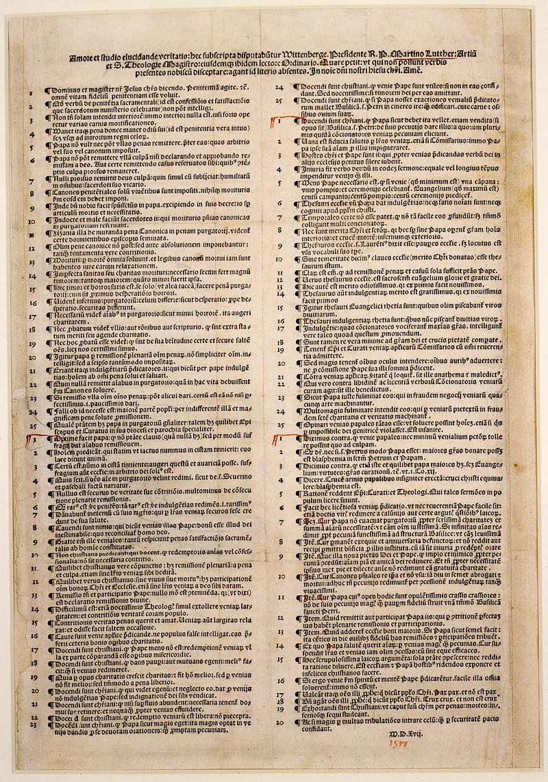 A single printed sheet from 1517 carrying Luther's ninety-five numbered theses in two dense columns of Latin, with a heading across the top and a few marks added later by hand in red.